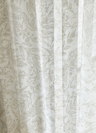 a close up of a curtain with a cat on it