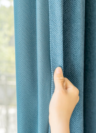 a person's hand is peeking through the curtains