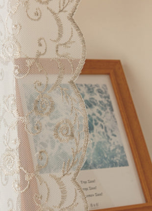 a picture frame and a curtain hanging on a wall