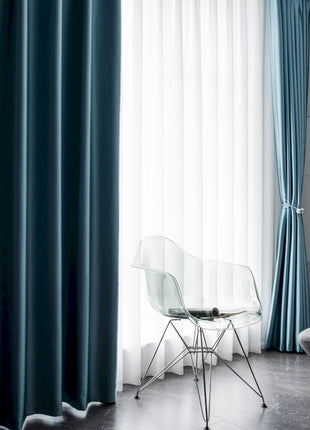 a living room with a chair and a book shelf