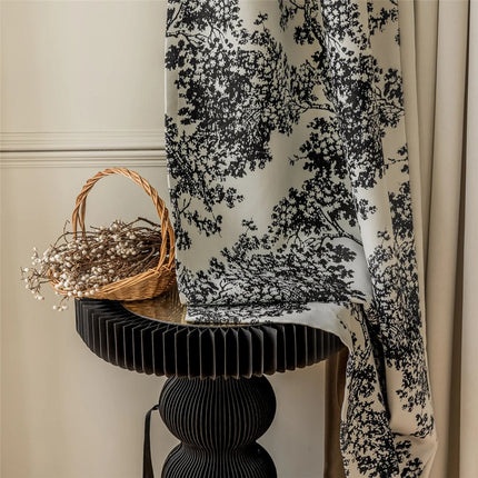 a basket sitting on a table next to a curtain