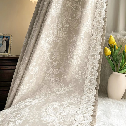 a vase with yellow flowers sitting on a bed