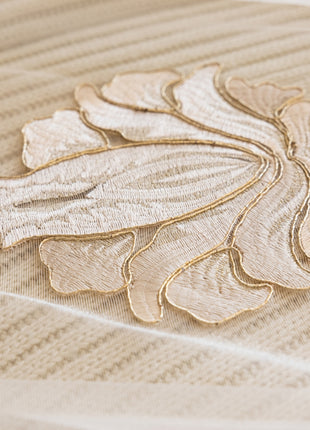 a close up of a bed with a decorative design on it