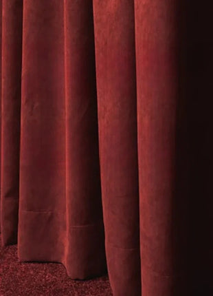a row of red curtains in a room