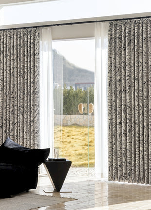 a living room with a black couch and a sliding glass door