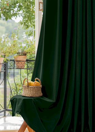 a basket of fruit sitting on a table next to a window