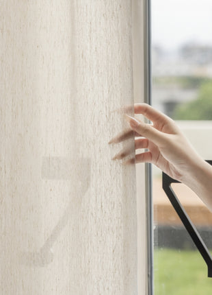 a person's hand reaching out of a window