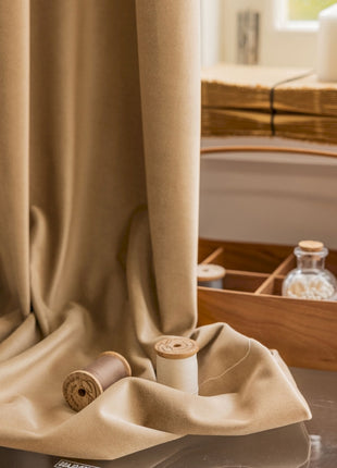a wooden table topped with a drawer and a curtain