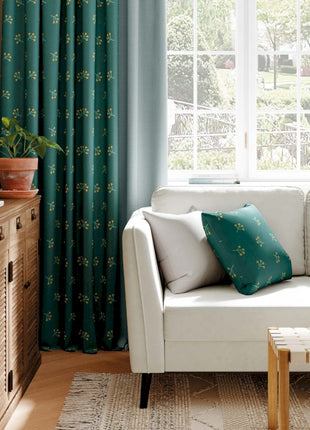a living room with a white couch and green curtains