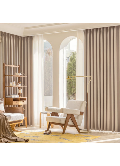 a bedroom with a large window and a chair