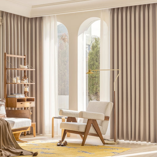 a bedroom with a large window and a chair