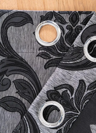 a close up of a pair of scissors on a piece of fabric