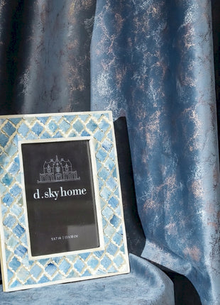 a picture frame sitting on top of a blue chair