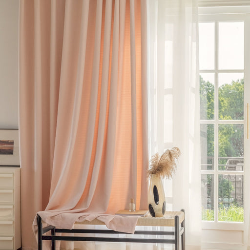 a room with a bed, a window, and a vase