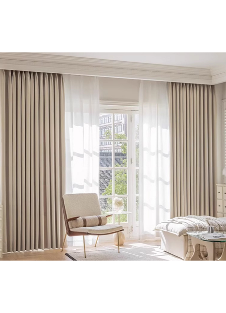 a well-lit living room with a comfortable chair, a glass table, and large windows with sheer curtains.