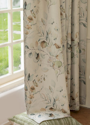 a window with a curtain and a chair in front of it