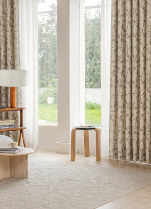 a living room filled with furniture and a large window