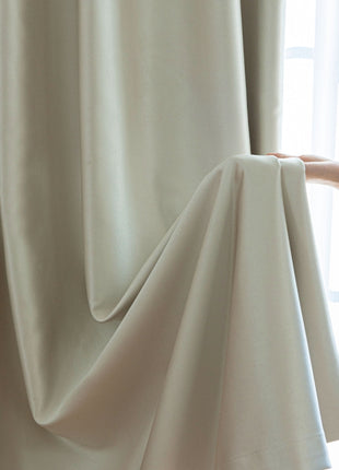 a person holding a curtain with their hand