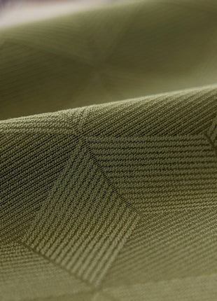 a close up of a green fabric with a diamond pattern