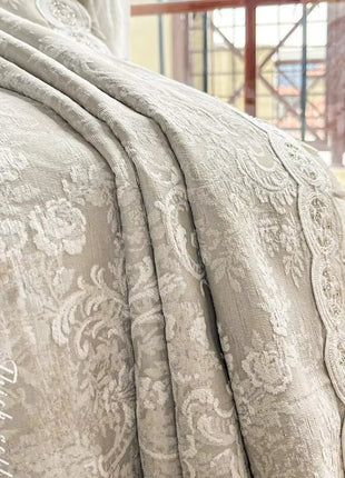 a bed with a white comforter on top of it