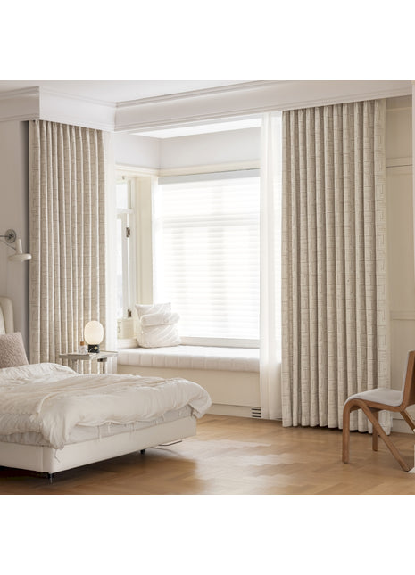 a bedroom with a white bed and a window