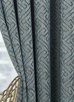 a close up of a curtain with a chair in front of it
