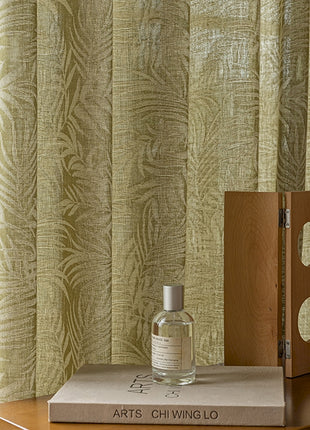 a bottle of perfume sitting on top of a book