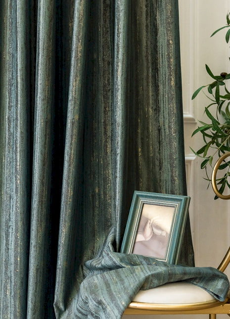 a picture frame sitting on a chair next to a curtain