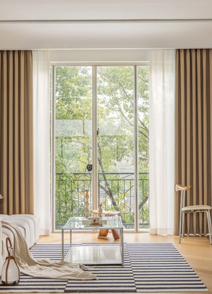 a living room filled with furniture and a large window