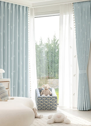 a teddy bear sitting in a chair in front of a window