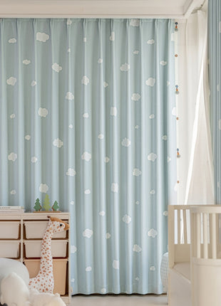 a baby's room with blue curtains and a white crib