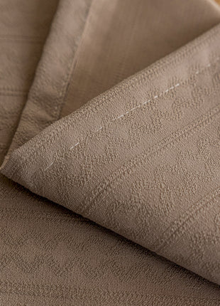 a close up of a bed with a sheet on it