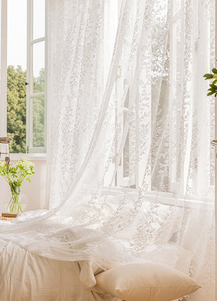 a bedroom with a white bed and a window