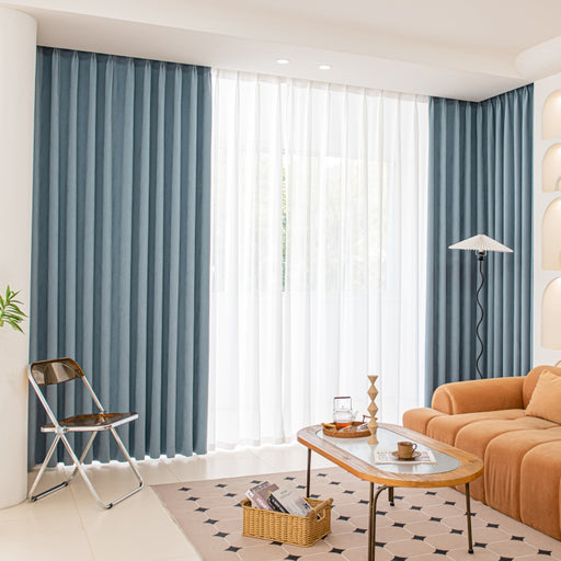 a living room filled with furniture and a large window