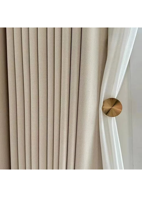 a close up of a curtain with a gold button on it