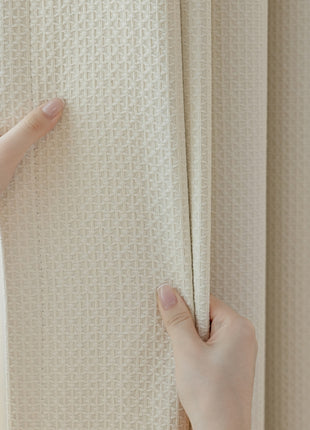 a person holding a curtain with their hands