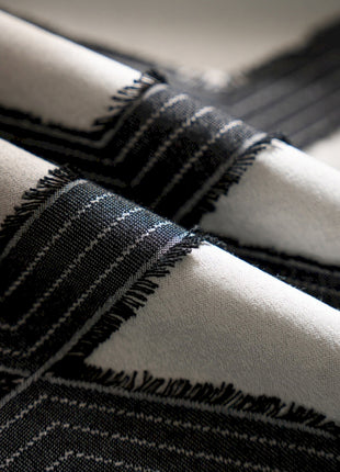 a close up of a black and white blanket