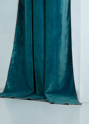 a green curtain with a white wall in the background