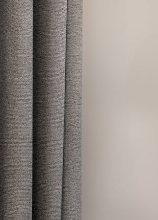 a cat sitting on a window sill next to a curtain