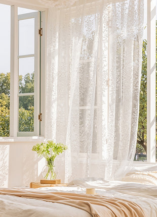 a bed sitting under a window next to a window sill