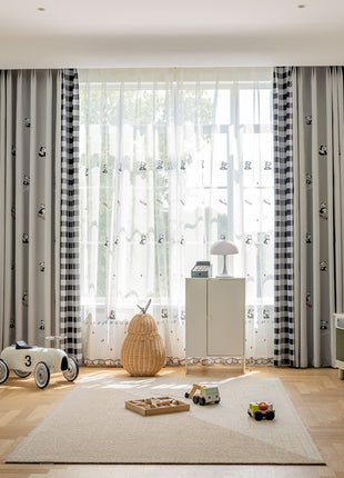 a child's room with a large window and a rug on the floor