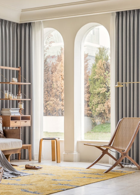 a living room filled with furniture and a large window