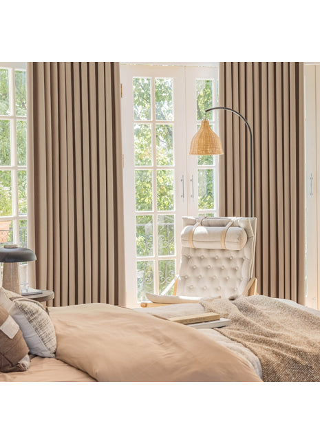 a bedroom with a bed, chair and window