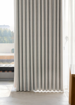 a room with a table, chair and a window