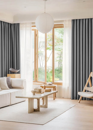 a living room filled with furniture and a large window