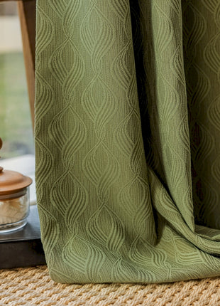 a window with a green curtain next to a window sill