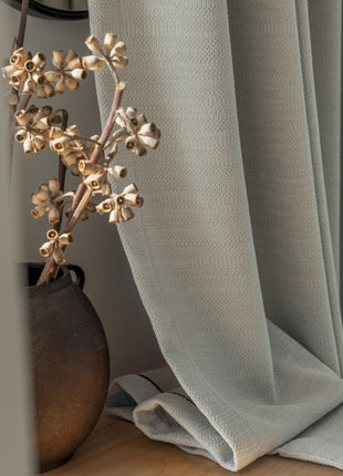 a close up of a flower on a curtain