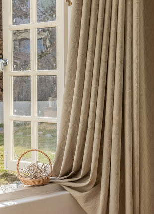 a window with a curtain and a basket on the window sill