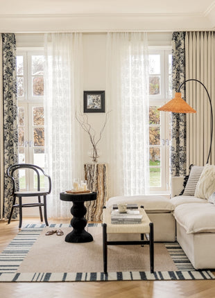 a living room filled with furniture and a lamp