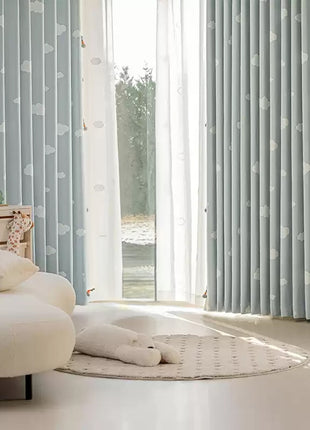 a bedroom with a white bed and blue curtains